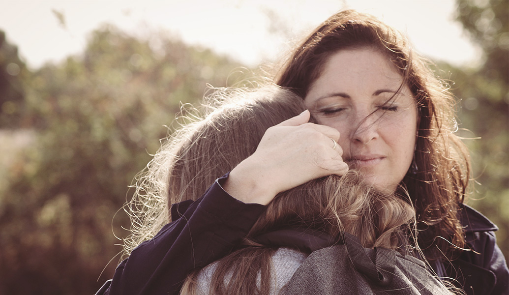 Woman comforting another woman