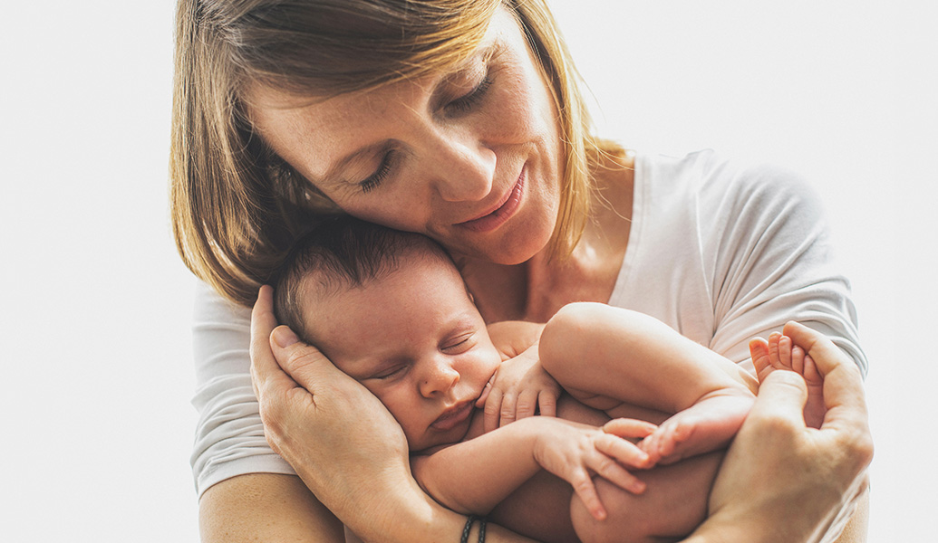 woman holding a newborn baby