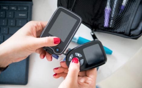 Woman testing her blood sugar levels